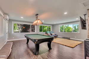 Rec room featuring recessed lighting, a wall mounted air conditioner, dark wood finished floors, and pool table