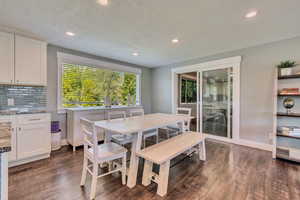 Dining space featuring baseboards, recessed lighting, and dark wood-type flooring
