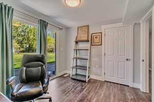 Home office featuring baseboards and dark wood finished floors