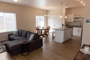 Living area with visible vents and dark wood-type flooring