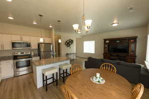 Dining space featuring an inviting chandelier, recessed lighting, visible vents, and wood finished floors