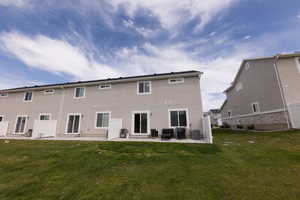 Back of house with a yard, an outdoor hangout area, a patio, and central air condition unit