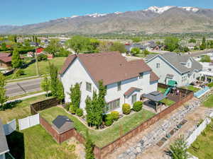 Aerial photo of back showing covered hot tub and playset area