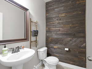 Guest half bath with distressed wood accent wall