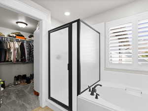 Primary bath with separate tub/shower and walk-in closet