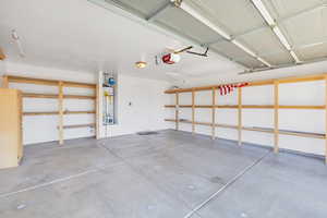 Garage featuring water heater and a garage door opener
