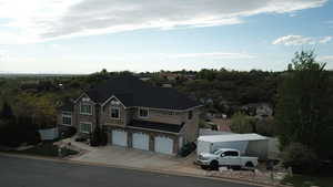 View of front facade featuring an attached garage and driveway