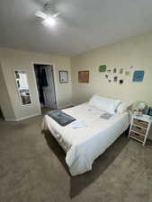 Bedroom with baseboards, a closet, a ceiling fan, and carpet floors
