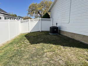 View of yard featuring central AC unit and a fenced backyard