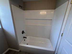 Full bath featuring shower / washtub combination