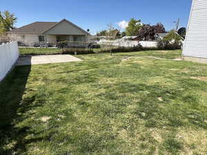 View of yard with a patio area and fence