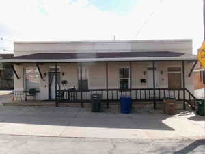 Back of house featuring covered porch