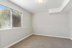 Carpeted bedroom featuring baseboards