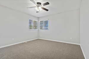 One of the three carpeted bedrooms on the 2nd level featuring ceiling fans, and visible vents