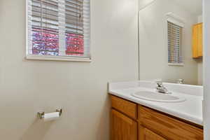 Half bathroom featuring plenty of natural light and vanity
