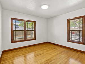 Unfurnished room featuring light wood-style floors and baseboards