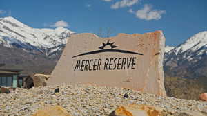 Community / neighborhood sign with a mountain view