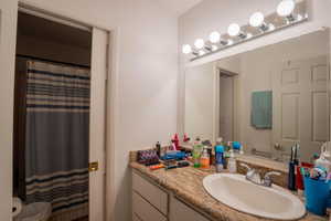Bathroom featuring vanity and a shower with shower curtain