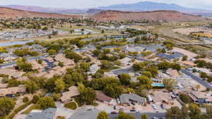 Birds eye view of property featuring a water and mountain view and a residential view