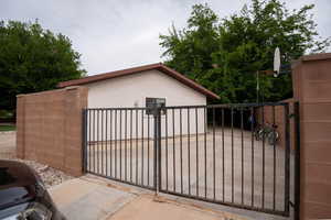 View of gate featuring fence