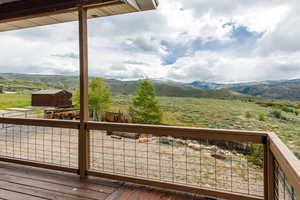 Deck featuring a mountain view, a view of countryside, and an outdoor structure
