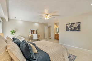 Bedroom featuring light colored carpet, a textured ceiling, recessed lighting, a ceiling fan, and baseboards