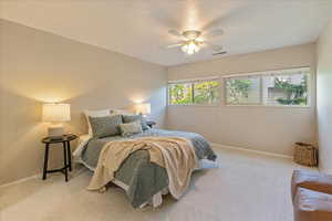 Bedroom with baseboards, a ceiling fan, visible vents, and carpet floors