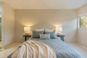 Carpeted bedroom featuring baseboards