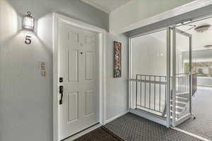 Doorway to property with covered porch