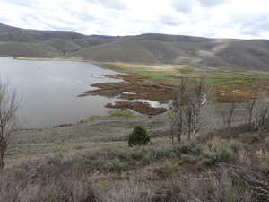 Property view of mountains featuring a water view