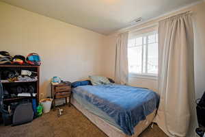 Bedroom featuring carpet and visible vents