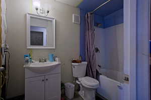 Full bathroom featuring toilet, shower / tub combo, vanity, and visible vents