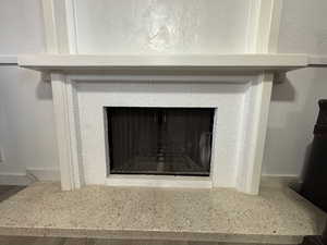 Details with a decorative wall and a fireplace