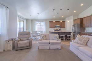 Living room with a notable chandelier, visible vents, and recessed lighting