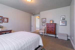 Carpeted bedroom featuring baseboards