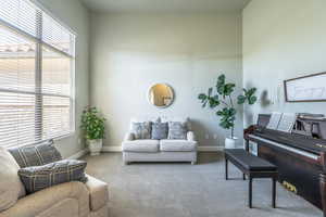 Sitting room with carpet floors and baseboards