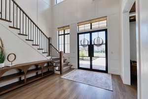 Entryway stairway, glass entry doors, and remote-controlled blinds