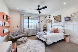 Bedroom 4 featuring board and batten decorative wall and walk-in closet