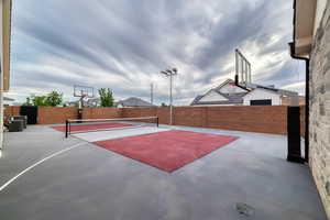 basketball/pickleball court with outdoor lighting