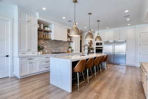 Professional column refrigerator and brick backsplash.
