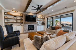 Wood ceiling beams, brick gas fireplace, remote control shades