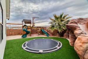 Professionally installed in-ground trampoline and custom private ship play area with spacious sandbox