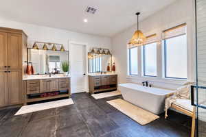 Primary bathroom has extra-large tiled flooring