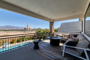 Covered deck with a mountain and temple views, and an outdoor living space