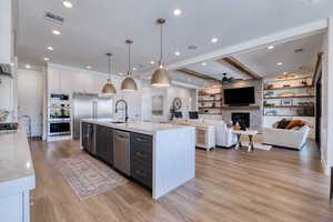 Kitchen features a quartz waterfall center island with sink