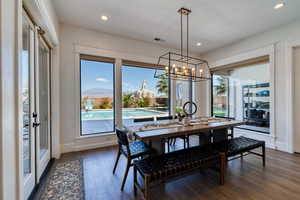 Dining space featuring picturesque windows and glass doors leading to the backyard
