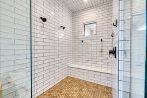 Primary bathroom enclosed double-headed, full tiled shower.