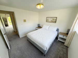 Carpeted bedroom featuring baseboards