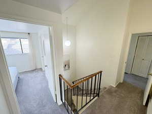 Interior space with carpet and an upstairs landing