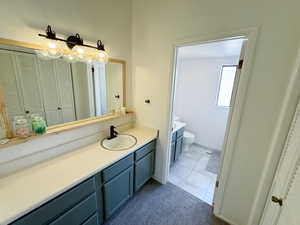 Full bath featuring toilet, a bathtub, vanity, visible vents, and tile patterned floors